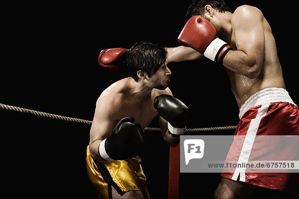 Boxers fighting in boxing ring