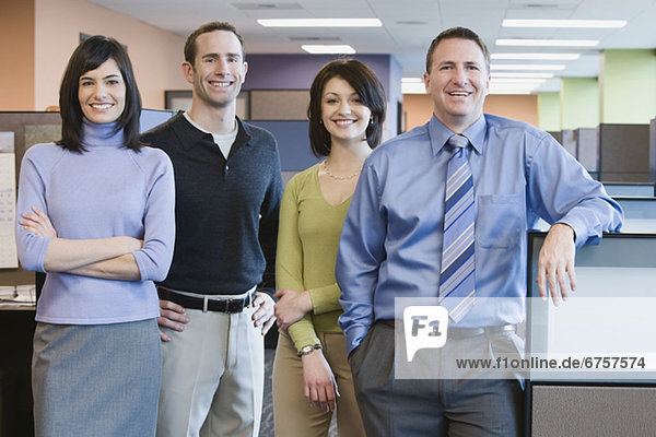 Multi-ethnic businesspeople standing in office