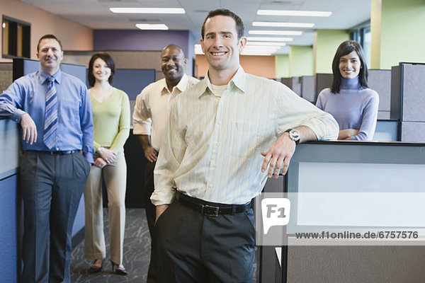 Businessman with multi-ethnic coworkers in background