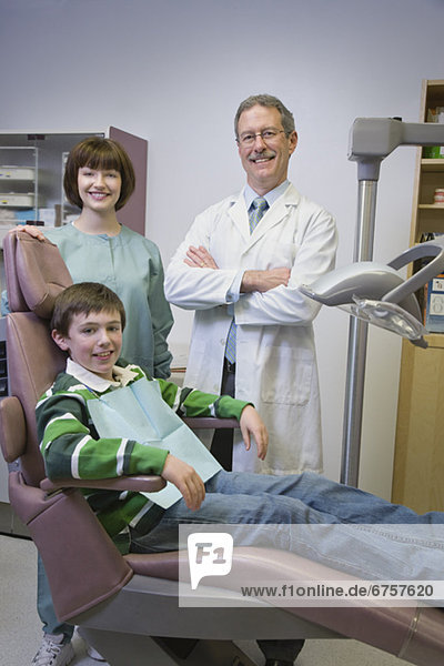 Dentist and dental hygienist with patient