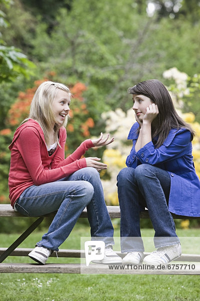 Girls talking in park