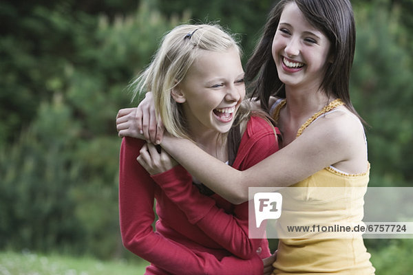 Girls laughing in park
