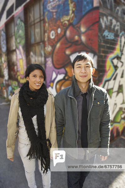 Young couple in alley with graffiti  Toronto  Ontario