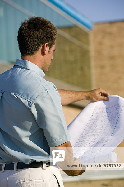 Architect Reading Blueprints at a Construction Site  York Region  Ontario