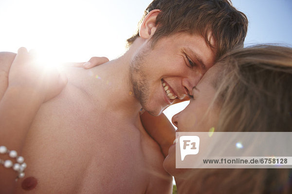 Young couple hugging on beach