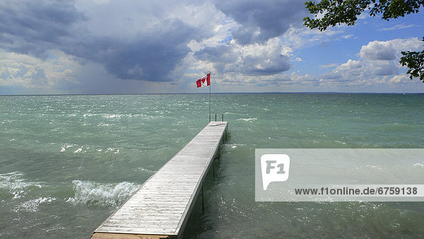 Dock and Canadian Flag  Gamebridge beach  Lake Simcoe  Ontario