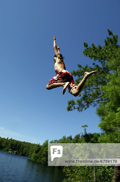 Teenage Boy Jumping off Cliff  Lac des Neiges  Quebec
