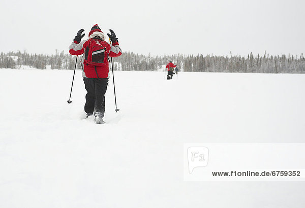 Snowshoeing across an unnamed lake on a snowshoeing excursion outside of Yellowknife  Northwest Territories