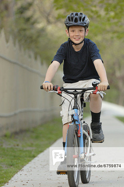 Boy Riding Bicycle on Sidewalk  Toronto  Ontario