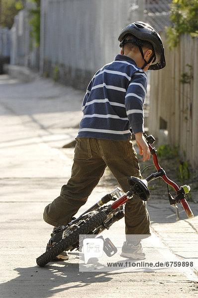 Boy Getting off Bicycle  Toronto  Ontario