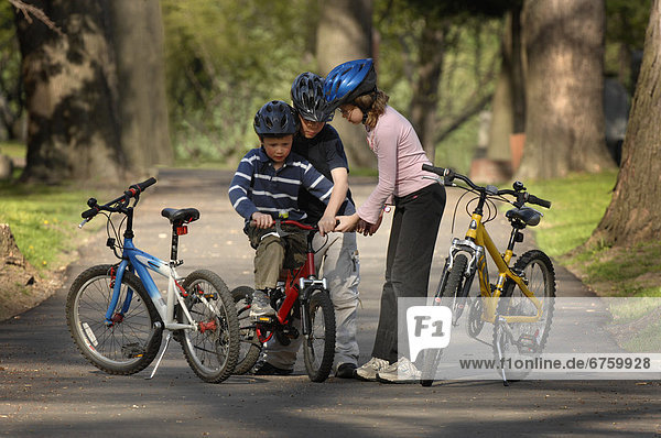 Boy Riding Bicycle with Sister and Brother Helping  Toronto  Ontario