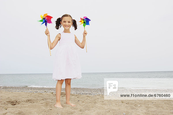 Young Girl Standing on Beach Holding Pinwheels  Toronto  Ontario