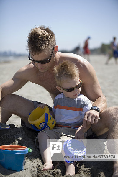 Father and Son at a Beach Playing in the Sand  Spanish Banks  Vancouver  British Columbia