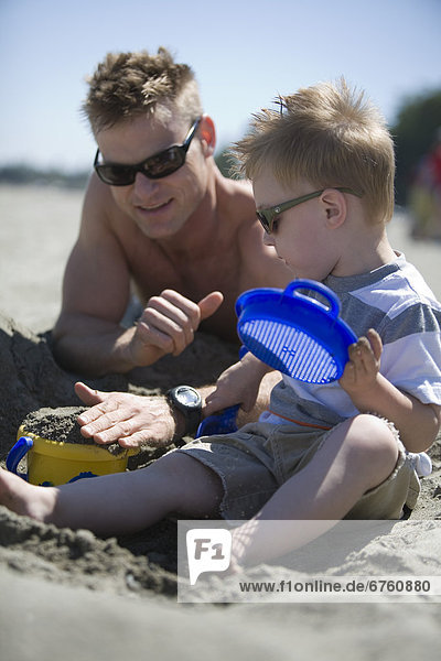 Father and Son at a Beach Playing in the Sand  Spanish Banks  Vancouver  British Columbia