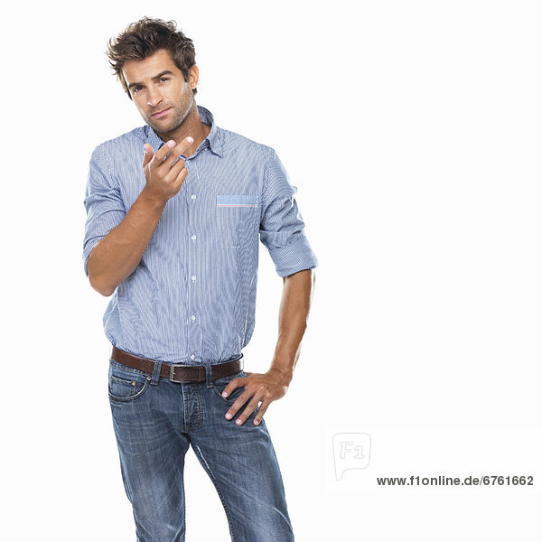 Studio shot of young thoughtful man gesturing