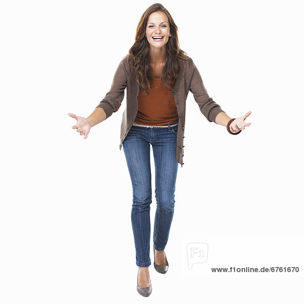 Studio shot of young enthusiastic woman smiling