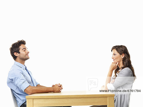 Business couple sitting at table for date