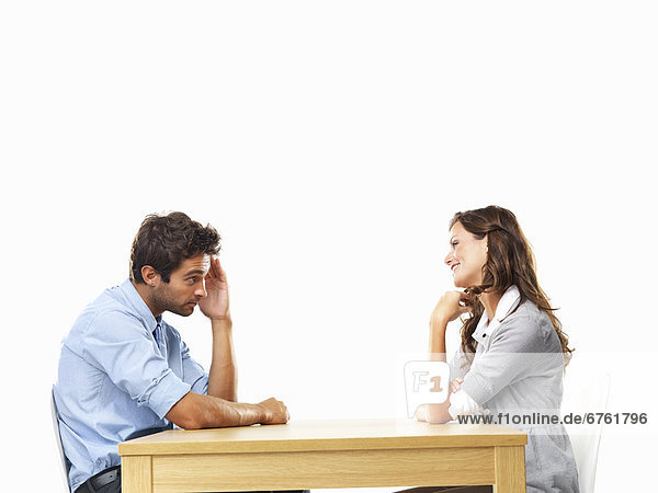 Business couple sitting at table for date
