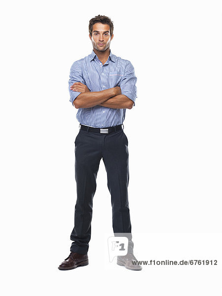 Studio shot of confident business man standing with hands folded