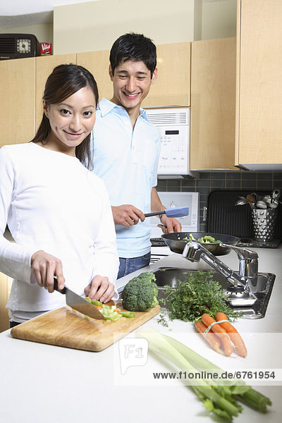 Couple Cooking together in a Condo  Vancouver  British Columbia