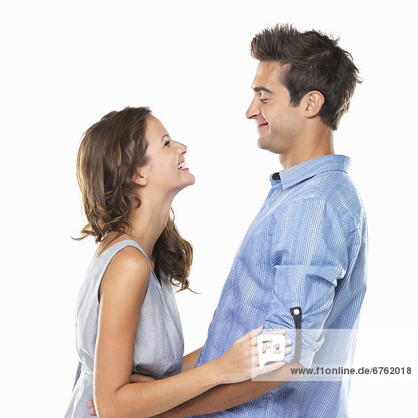 Couple in love looking at each other and smiling