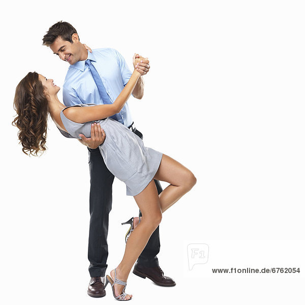 Studio shot of happy couple dancing