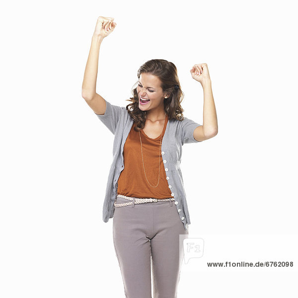 Studio portrait of excited young woman cheering