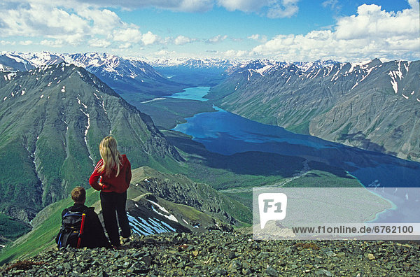 Hikers overlooking Kathleen Lake and St. Elias Mountains on top of King's Throne  Kluane National Park  Yukon