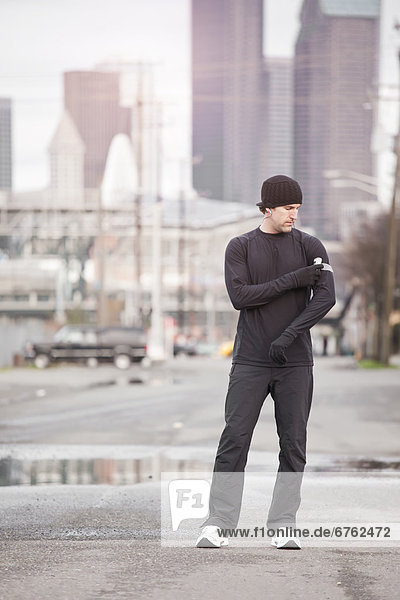 USA  Washington  Seattle  man in workout wear in street