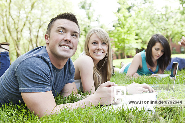 College students relaxing on grass
