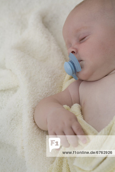 Baby sleeping with pacifier in mouth