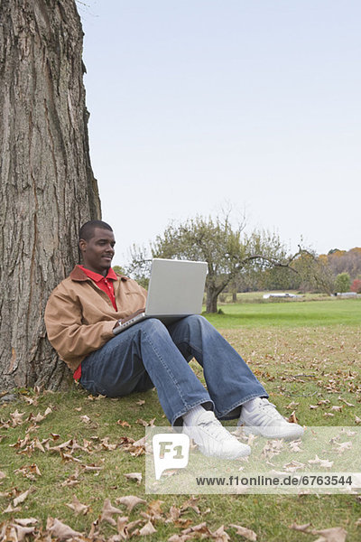 Man using laptop outside