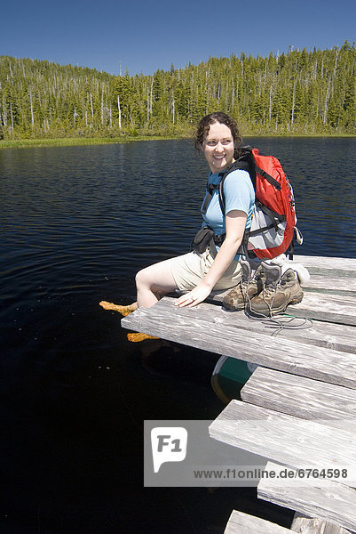 Woman Sitting on Dock  Noyse Lake  Vancouver Island  BC