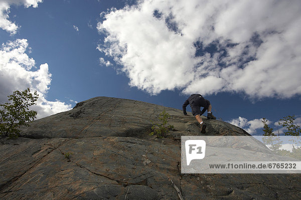 Rock climbing along the shores of the Great Slave Lake in Yellowknife  Northwest Territories