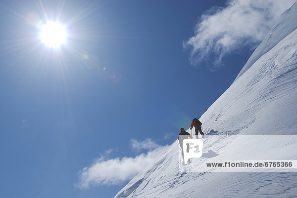 Skiers heading along ridge of unnamed summit  Marriot Basin area  Coast Mountains  British Columbia