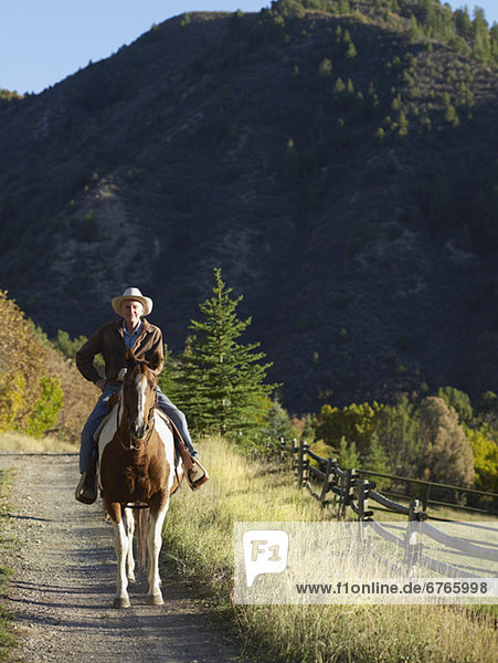Senior man horseback riding  Colorado  USA