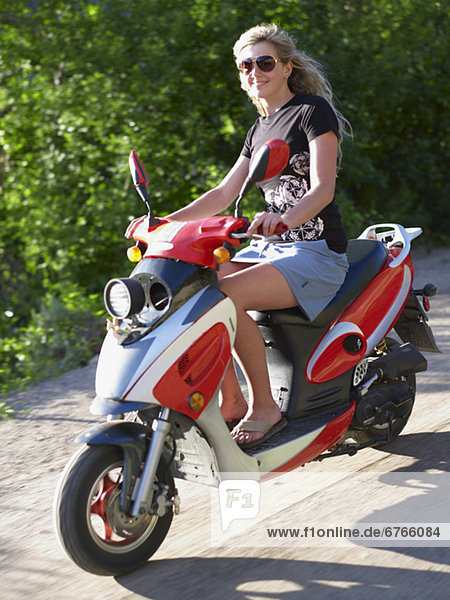 Young woman on scooter