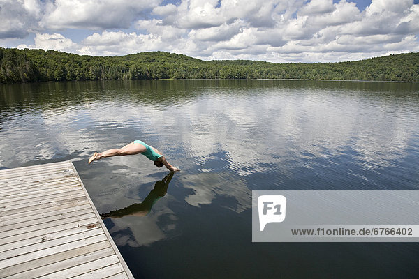 Woman diving  Smoke Lake  Algonquin Park  Ontario