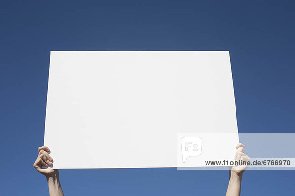 USA  Arizona  Holbrook  Human hands holding blank placard