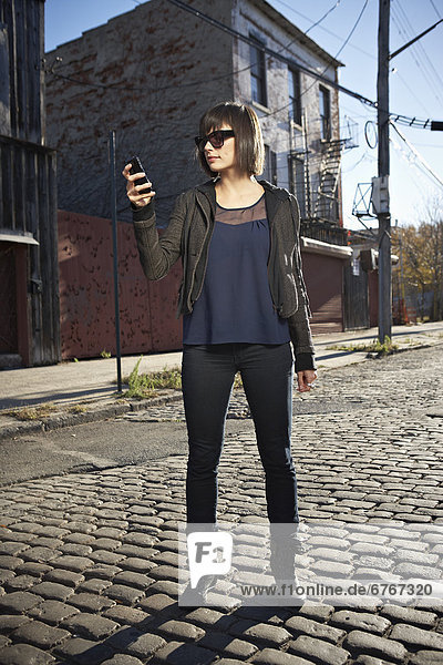 USA  New York City  Brooklyn  woman in street using phone