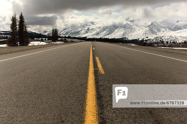 Haines Highway and snow-covered peaks of St. Elias Range in distance  Northern British Columbia