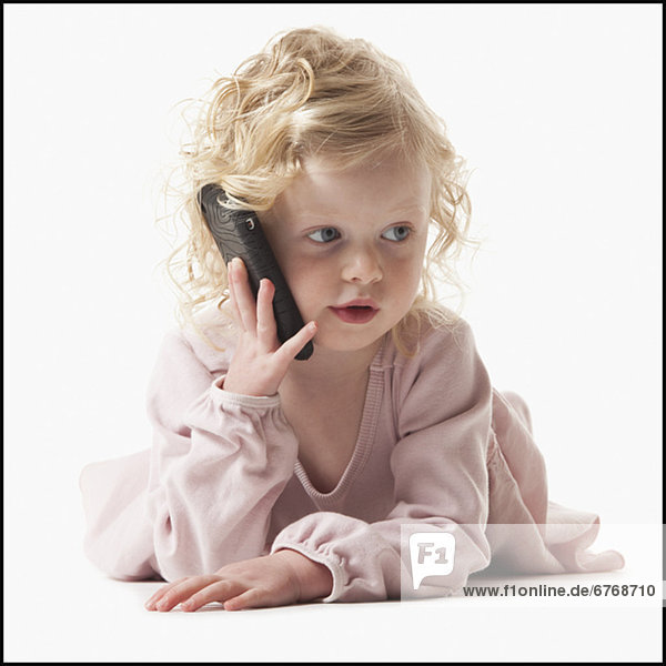 Young girl playing with a cellular phone