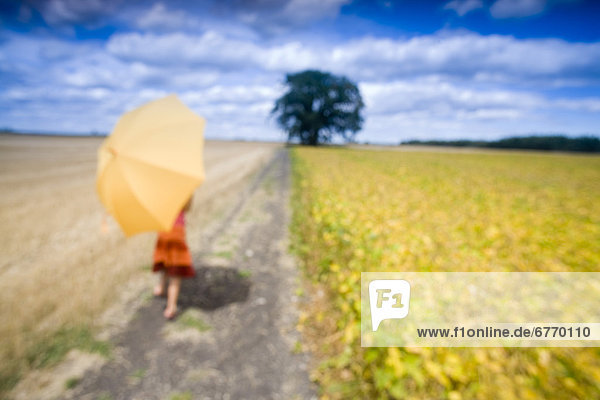 Blurred Image of Girl with Umbrella in Field  Manitoba