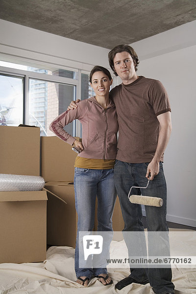 Man and Woman in Empty Condo with Boxes and Paint Roller  Toronto  Ontario