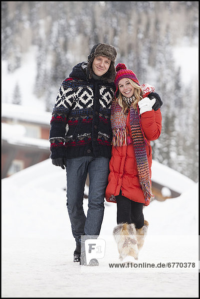 USA  Utah  Salt Lake City  Portrait of young couple walking in snow