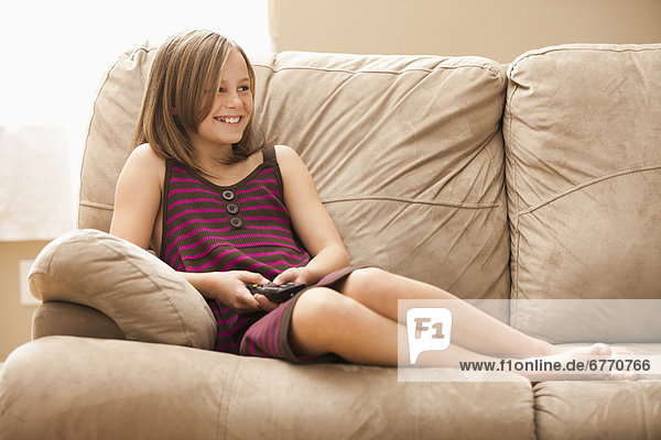 USA  Utah  Lehi  Girl (10-11) sitting on sofa  watching TV