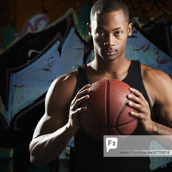 USA  Utah  Salt Lake City  Portrait of young man with basketball