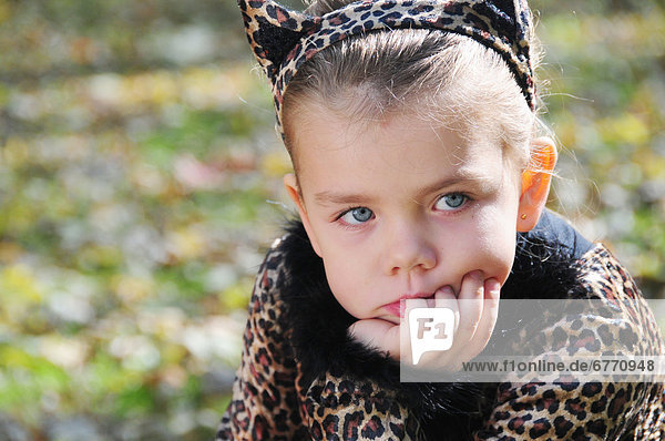 Little girl dressed as cat with pensive expression  Simcoe  Ontario