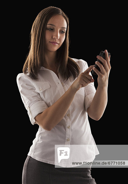 Young attractive businesswoman text messaging