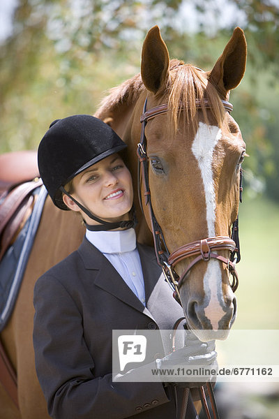 Young woman in riding gear with a horse  Cambridge  Ontario